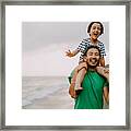 Cheerful Father Carrying His Daughter On Shoulders On Beach Framed Print