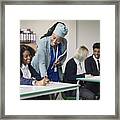 Cheerful Teacher Helping Student In Secondary Classroom Framed Print