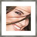 Close Up Of A Young Attractive Caucasian Brunette Who Smile Into The Camera As Her Hair Is Tossed In Front Of Her Face Framed Print