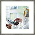 Close Up Of Young Male Doctor Using Digital Tablet Framed Print