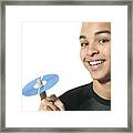 Close Up Shot Of A Teenage Male As He Holds Up A Cd On His Finger Framed Print