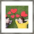 Couple Laying In Grass,surrounded By Hearts. Framed Print
