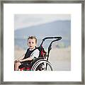 Cute Young Boy On The Wheelchair By The Sea Framed Print