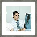 Doctor Sitting Across From Female Patient, Holding X-ray Framed Print