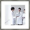 Doctors And Nurse Talking Framed Print