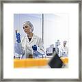 Female Worker Inspecting Packs Of Tablets In Pharmaceutical Factory Framed Print