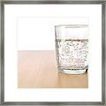 Glass Of Sparkling Water On Table Framed Print
