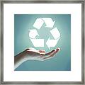 Glowing Recycling Sign Floating Above Hand Framed Print