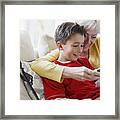 Grandmother And Grandson Playing Video Game Framed Print