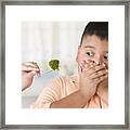 Hispanic Boy Covering Mouth Next To Broccoli Framed Print