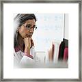 Hispanic Doctor Using Computer At Desk Framed Print