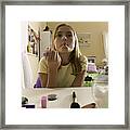 Lifestyle Portrait Of A Teenage Female As She Looks In The Mirror And Puckers Up Her Lips Framed Print