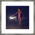 Little Girl Playing With Bengal Fire On The Beach At Dusk. Framed Print