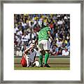 Male Soccer Player Assisting Opponent After Tackle, In Stadium Framed Print