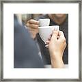 Man And Woman Sitting At Cafe Table, Close-up (focus On Woman's Hand) Framed Print