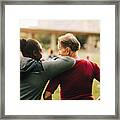 Man And Woman Talking While Looking At Senior Friends In Park Framed Print