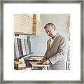 Man Looking At Samples Of Wood Framed Print