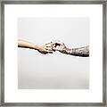 Man With Tattooed Arm Placing Ring On Finger Of Young Woman, Close-up Of Arms And Hands Framed Print