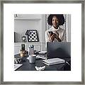 Mid Adult Woman Working In Her Home Office, Using Smartphone Framed Print