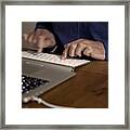 Midsection Of Man Using Laptop On Table Framed Print