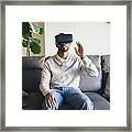 Mixed Race Man Using Virtual Reality Goggles Framed Print