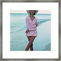 Model On A Beach In A Pink Shirt And Straw Hat Framed Print