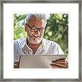 Modern Senior Man With Tablet Framed Print