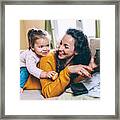 Mother And Daughter Having Fun Online Framed Print