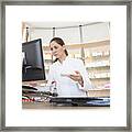 Pharmacist In Pharmacy Using Computer Framed Print