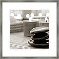 Polished Stone Cairn And Candles Burning In A Spa Framed Print