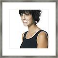 Portrait Of A Teenage Girl In A Black Tank Top As She Turns And Smiles Into The Camera Framed Print