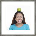 Portrait Of Woman Balancing Apple On Head Framed Print