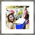 Portrait Of Woman Helping Man Carry Cooler Outside Tents At Music Festival Framed Print