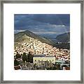 Rainbow In A Cloudy Sky Above The Houses Of Horio. Framed Print