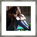 Sad Teen With A Phone In Her Bedroom Framed Print
