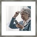Senior Woman Having Vision Problems Framed Print