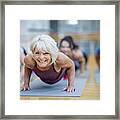 Senior Woman In Fitness Class In A Plank Pose Smiling Stock Photo Framed Print