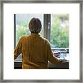 Senior Woman Standing Near The Kitchen Sink And Looking Through Window Framed Print
