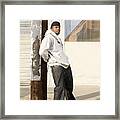 Serious Man Leaning Against Pole Framed Print