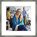 Smiling Businesswoman Sitting At Creative Office Framed Print
