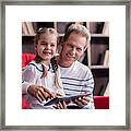 Smiling Girl Resting With Her Grandfather And Holding The Tablet Framed Print