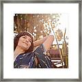 Smiling Young Woman Lying Back In A Patio Deck Chair Framed Print