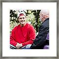 Student And Teacher Talking On Park Benches Framed Print