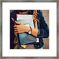 Teenage Girl Holding Books, Notebooks And Pencils Standing Against Wall Framed Print