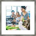 Thai Family Portrait Having Fun At The Joint Cooking. Modern Style Interior Of Kitchen. Framed Print