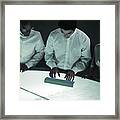 Three People With Hands On Table, High Angle View Framed Print