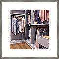 Walk In Closet With Clothes Hanging And Shoes On Shelving Framed Print