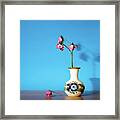 Wilted Roses Against Blue Framed Print