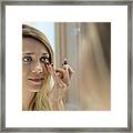 Woman Applying Cosmetics Framed Print