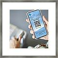 Woman Checking Covid-19 Vaccine Passport On Cellphone Framed Print